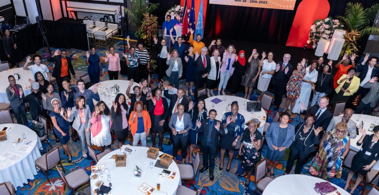 Aerial image of people waving in conference centre