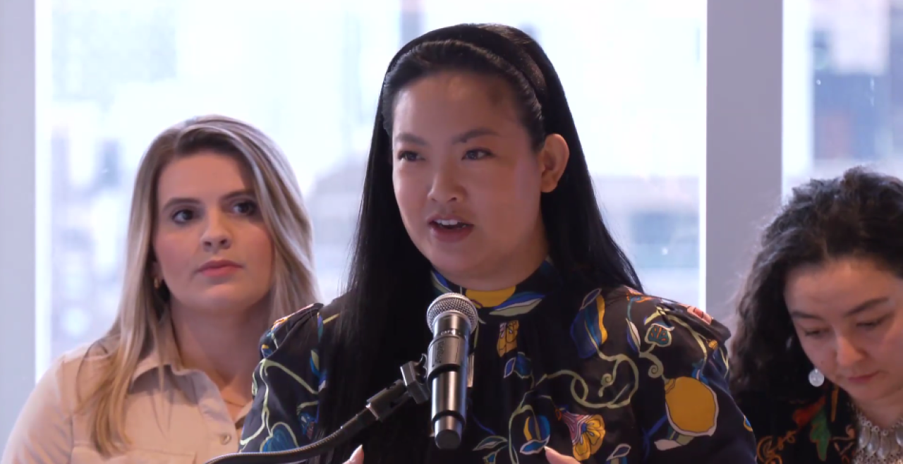 Amanda Nguyen speaking at lectern