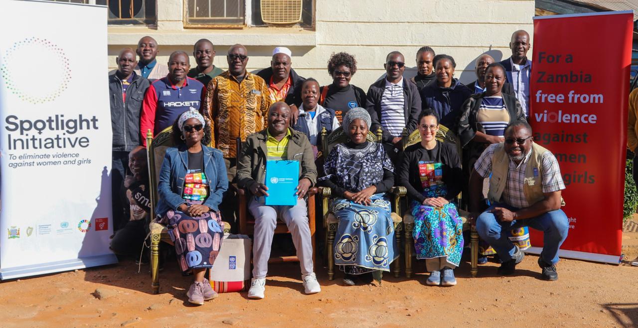 A photo of Chief Chanje of Eastern Zambia with UN and Civil Society representatives at his chiefdom. The chief supports gender equality and women's empowerment. 
