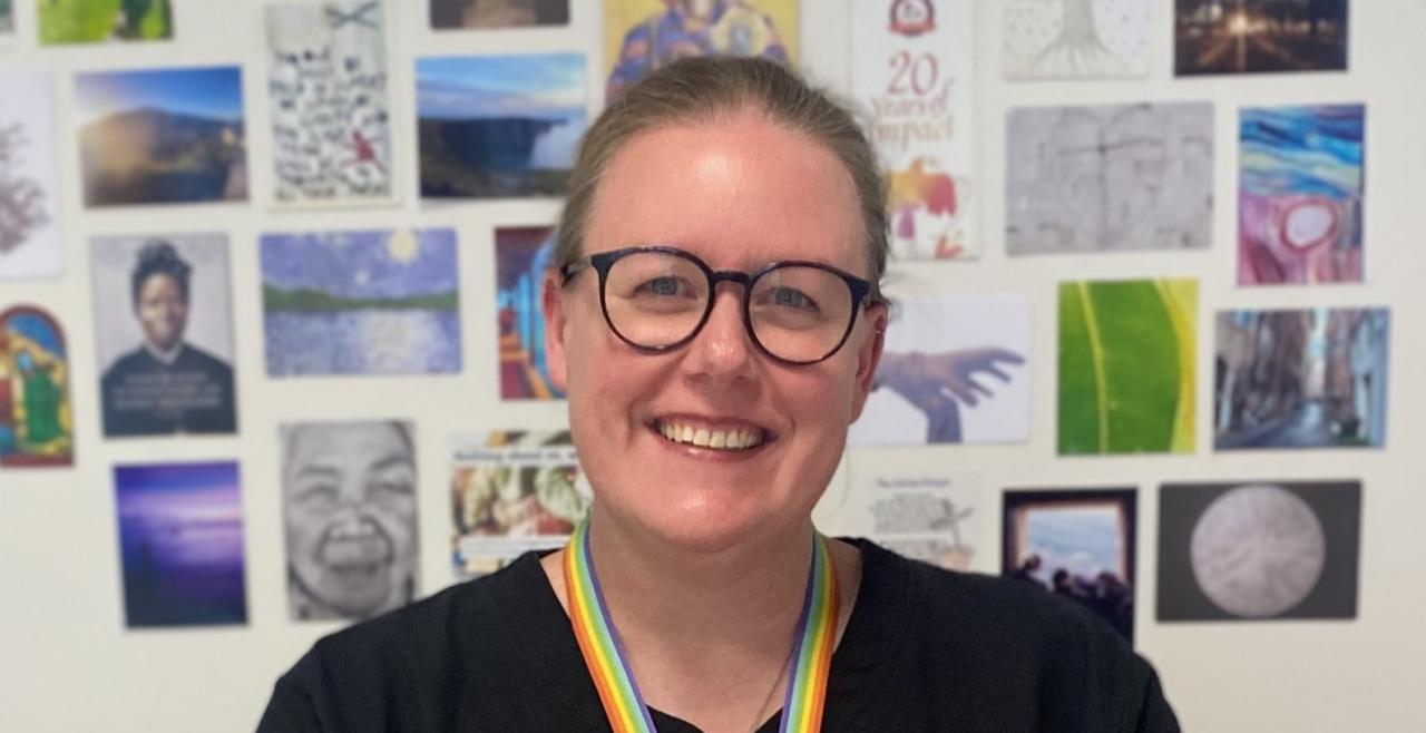 Sarah Puls wearing glasses and smiling at camera