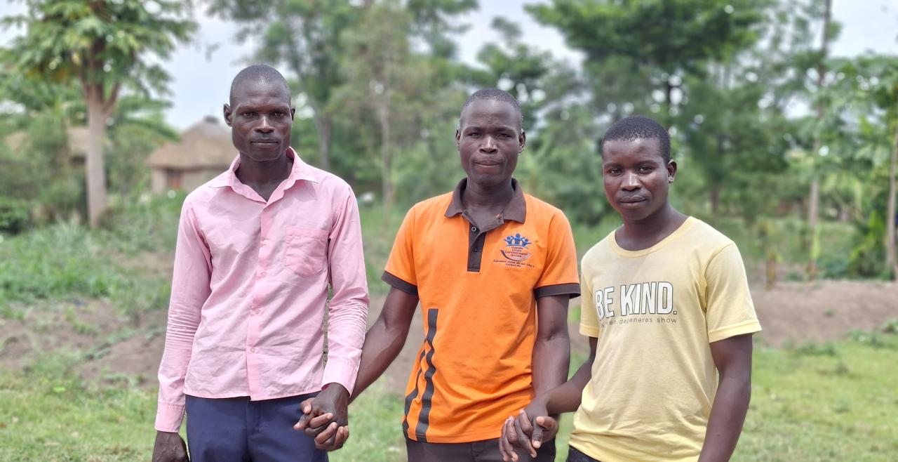 Onyango Vincent (middle) and his mentees, Owere Patrick (L) and Ochieng David joining hands
