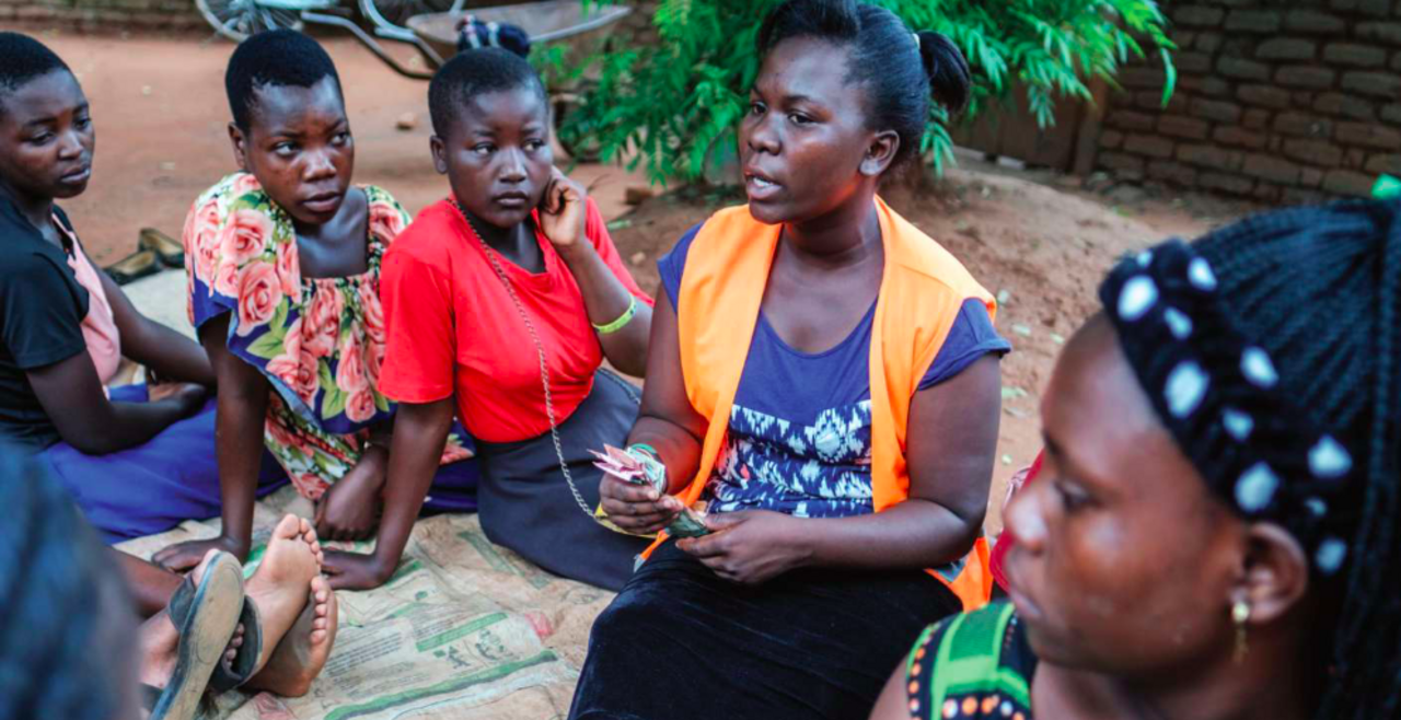 Elestina Joseph seated with other women in discussion