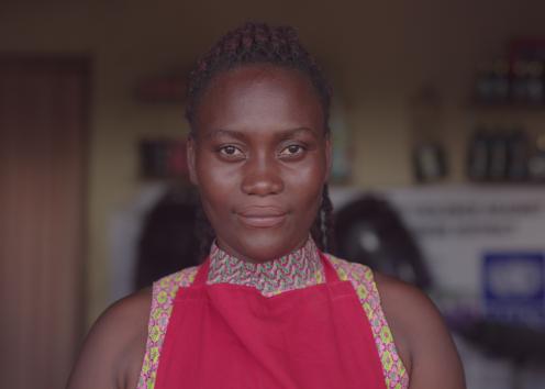 A smiling woman looks into camera