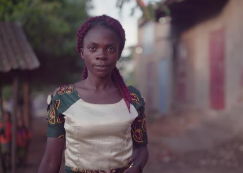 A smiling woman walking down a street