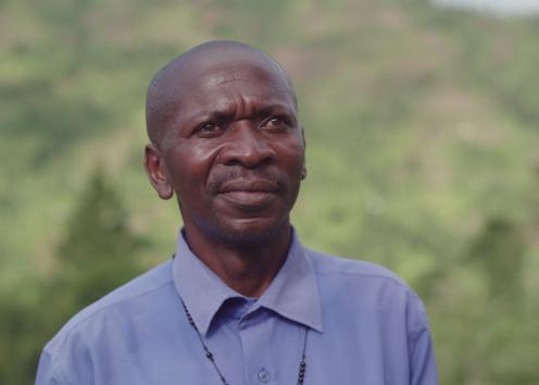 Close up of a smiling man standing in mountains